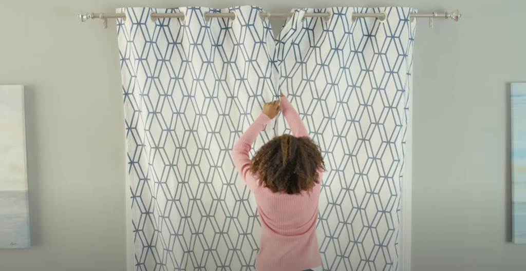 woman hanging curtains-home-decoration